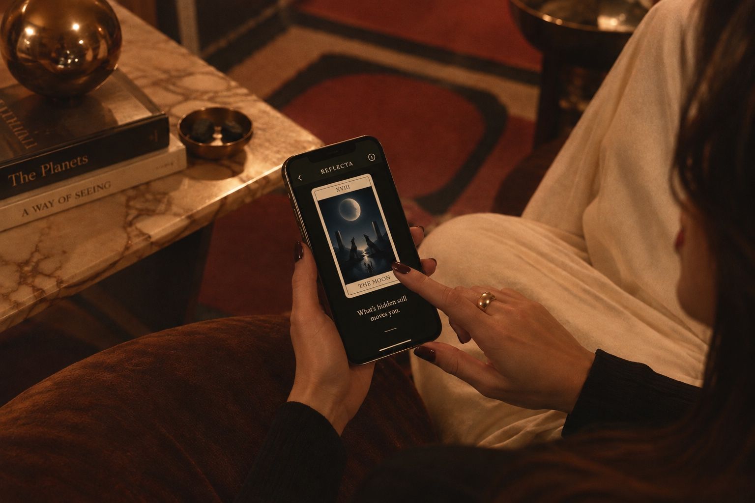 Someone settled into an armchair, reading a card in Reflecta on their phone.